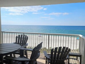 A balcony with Adirondack chairs and a view of the beach. - Sandy Key 312: 2 BR/2 BA Beachfront Condo in Perdido Key, FL On-Site Rental Office, Sleeps 6 (Pensacola)