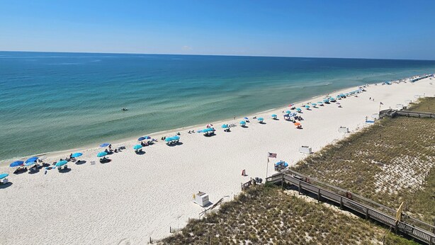 A beach with white sand, clear blue water, and a wooden boardwalk. - Sandy Key 416:  2 BR / 2BA Gulf Front Condo in Perdido Key, FL.  Sleeps 6 (Perdido Key)