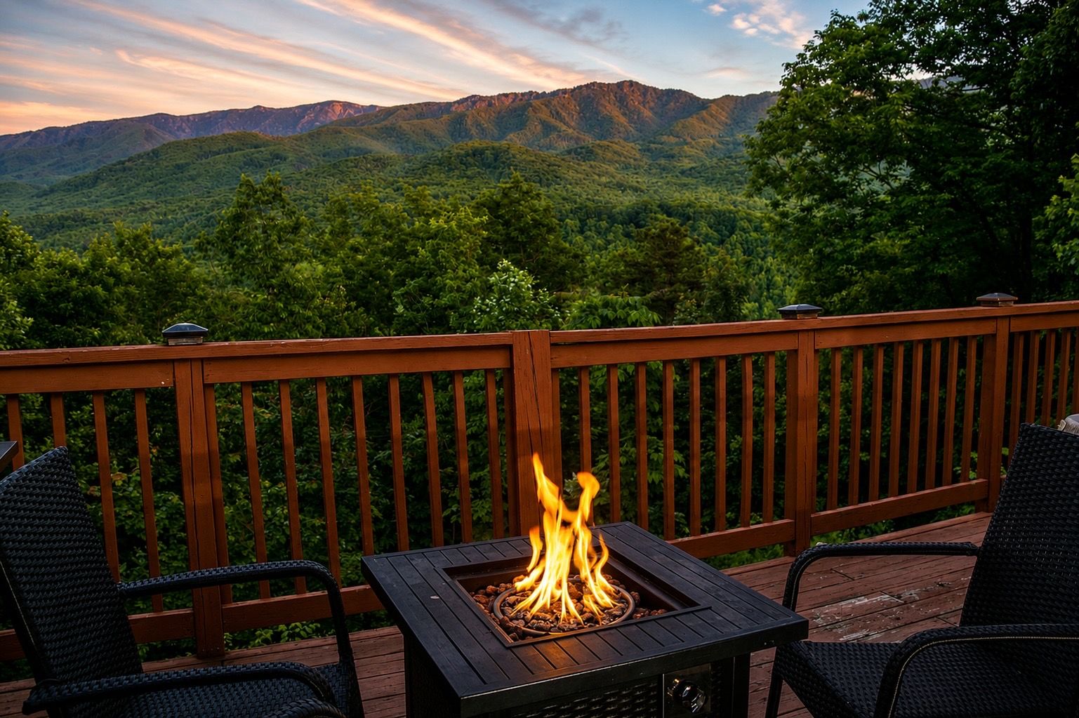 A deck with a fire pit and chairs, overlooking a mountainous landscape.
