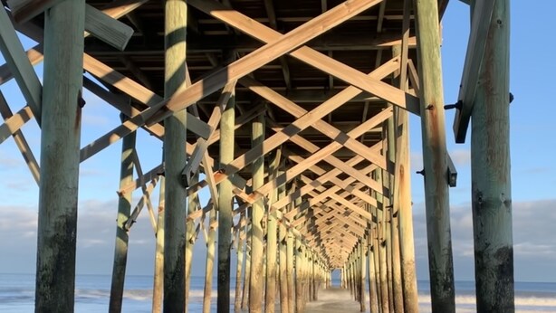 A wooden pier extending into the water with a clear view of the sky and ocean. - Perfect Year-Round! 2nd floor golf course condo, pool & hot tub, close to beach (Pawleys Island)