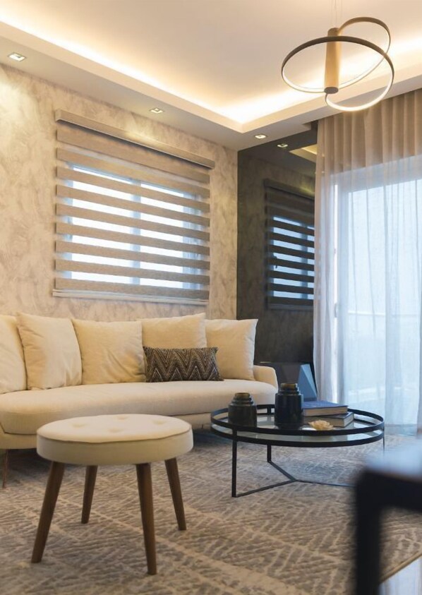 Relax in this stylish living room with a sofa, coffee table, and patterned rug.