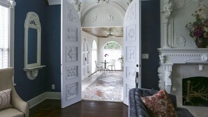 An open doorway leading to a dining area with a patterned floor and a table with chairs. - The Kenwood Gables B&B (St. Petersburg)