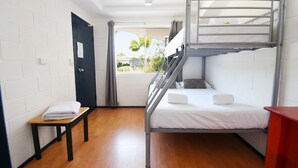 A bunk bed room with a small table and a window with curtains. - Caloundra Backpackers - Hostel (Caloundra)
