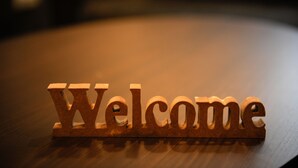A wooden sign with the word "Welcome" on a wooden surface. - Hostel Hideaway (Tokyo)