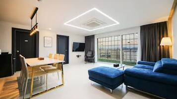 Family Suite | Living area | 55-inch LCD TV with digital channels, TV, Netflix