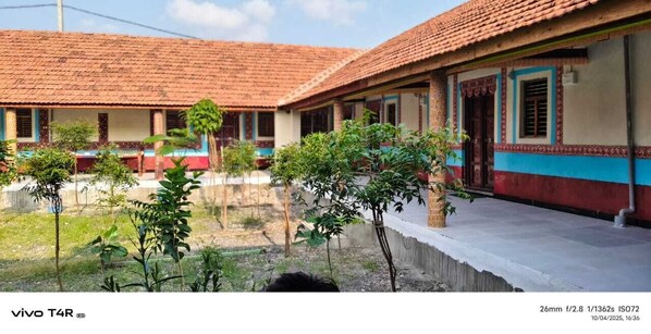 A row of traditional houses with tiled roofs and a small garden area in front.