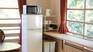 A compact kitchenette with a microwave, refrigerator, and small storage units. - The Railway Hotel Koyasan Pilgrimage Railway (Kudoyama)