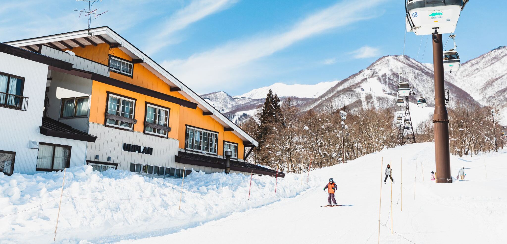 A modern building with a ski lift in the background.