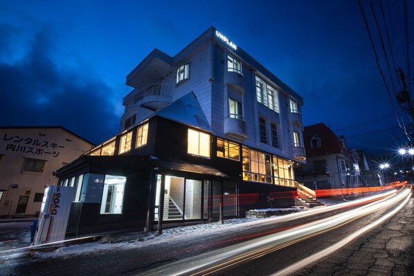 A multi-story building with a prominent 'UNPLAN' sign at the top.