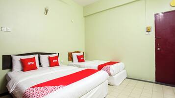 A hotel room with two beds, each with white bedding and red accents, a red door, and a light green wall.