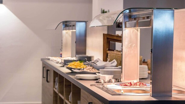 A buffet setup with a variety of food items and a self-service beverage station. - Drexels Parkhotel am Schloss (Krumbach)