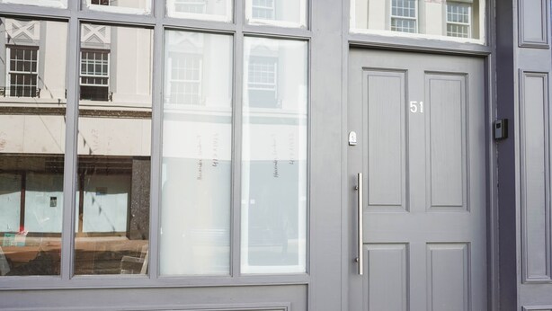 A grey door with the number 51, a window with reflections, and a doorbell. - 1 Bed Flat in Pedestrianized High Street (Dover)
