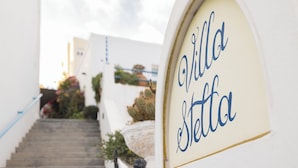 A staircase leading to a building with a sign reading "Villa Stetta." - Villa Stella (Santorini)