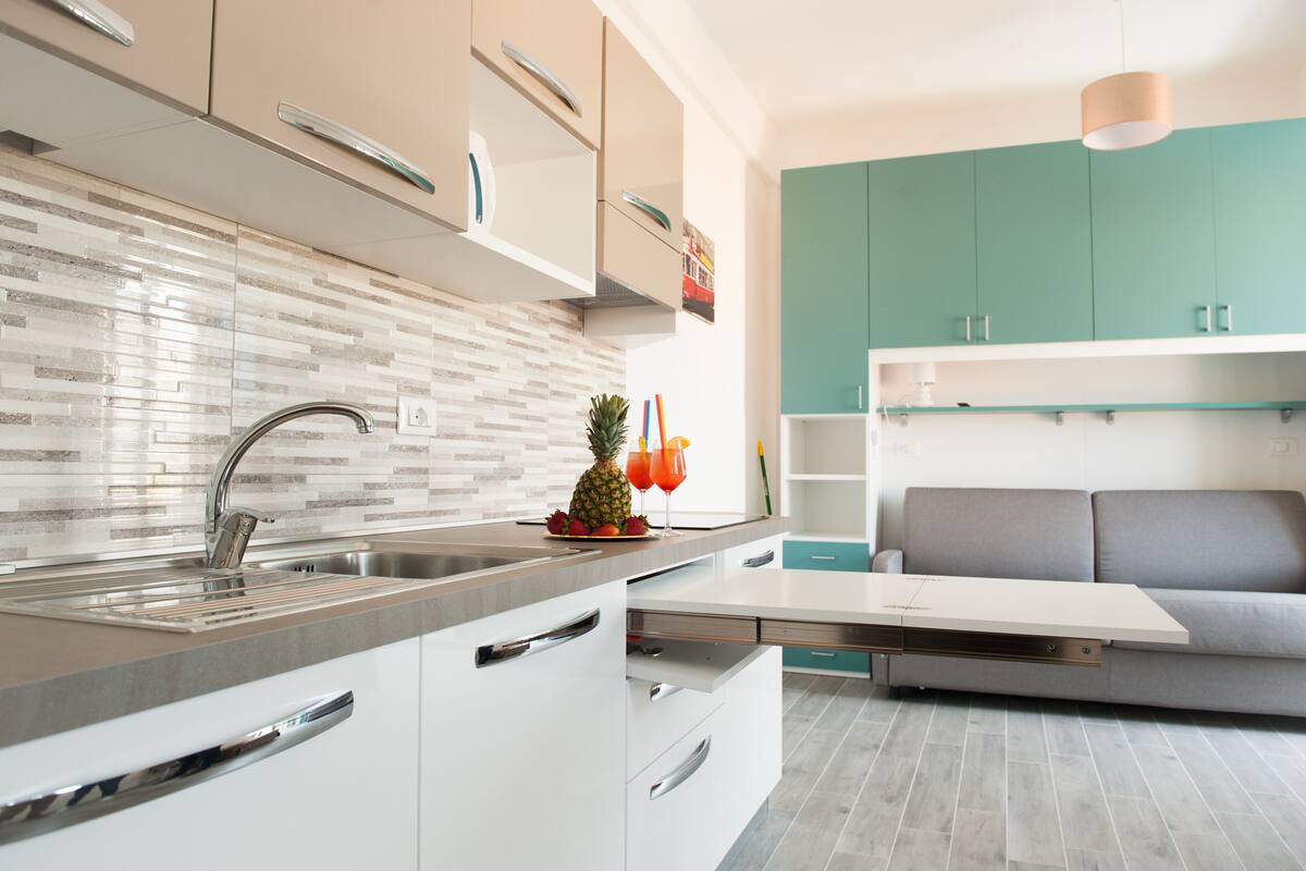 Full-sized fridge, stovetop, electric kettle, cookware/dishes/utensils