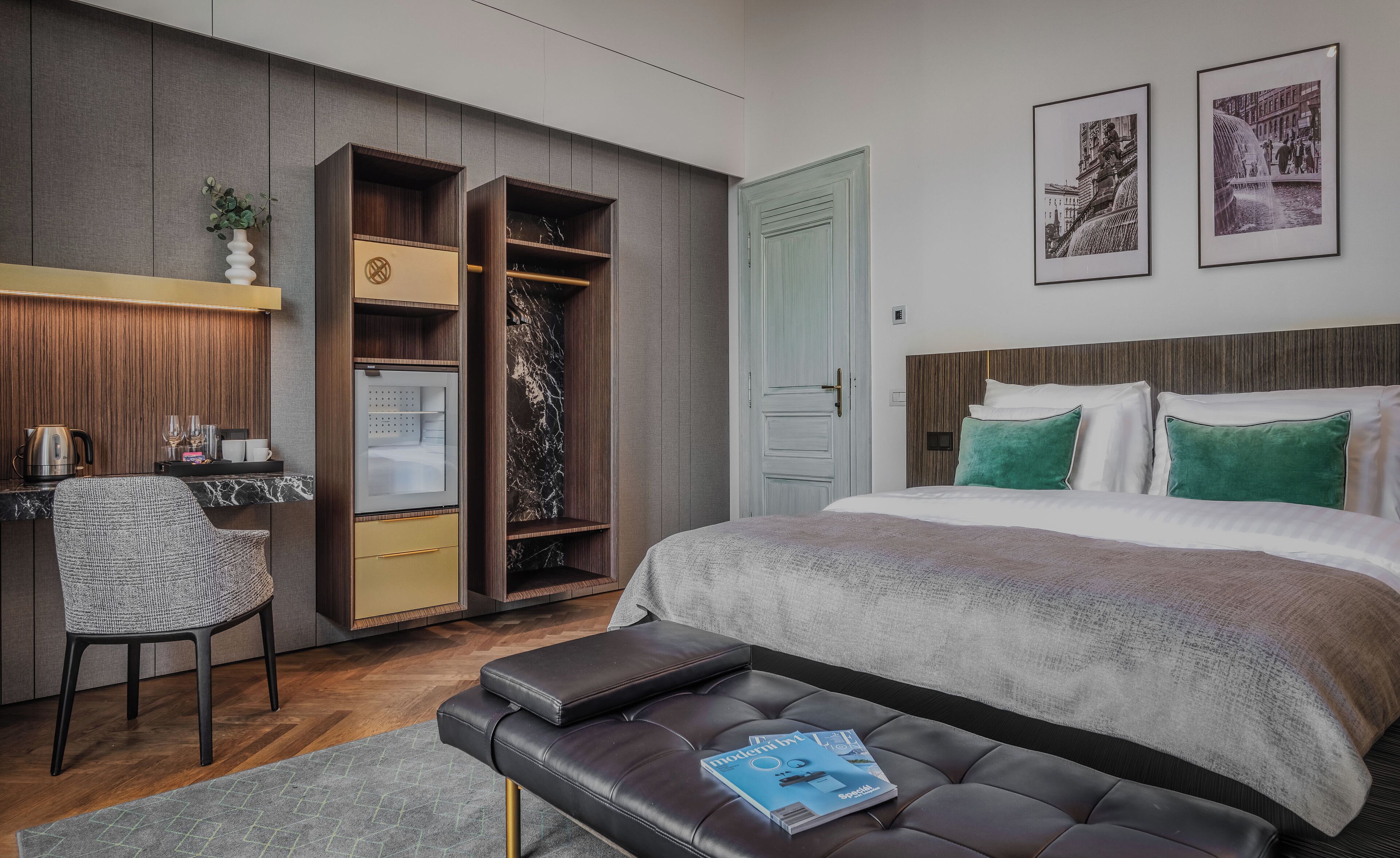 A modern bedroom with a bed, a desk, a wardrobe, and a bench.