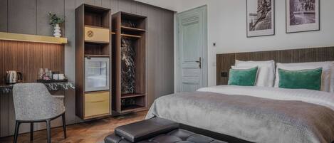 A modern bedroom with a bed, a desk, a wardrobe, and a bench.