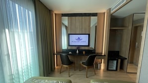 A hotel room with a desk, two chairs, a television displaying 'RADAIR OTEL', and a bed. - Radar Otel (Istanbul)