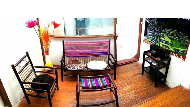 A wooden floor with two chairs and a small table. - the heart of cusco  (Cusco)