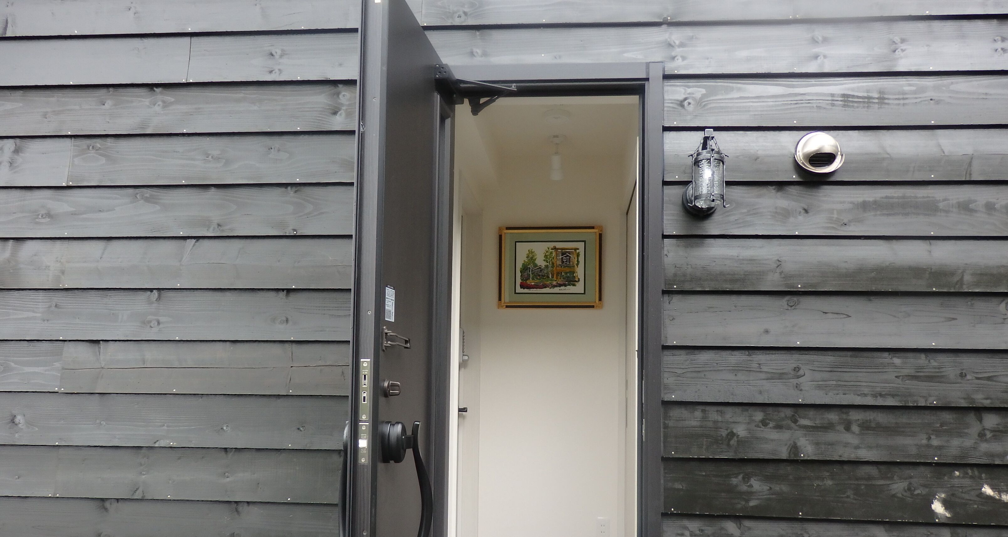 A wooden exterior with a door leading to an interior space.