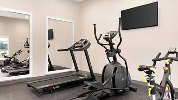 A gym with treadmills, an elliptical, and a stationary bike.