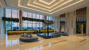 A spacious lobby with a modern design, featuring a large seating area, a central water feature, and large windows offering views of the outdoors. - Dusit Thani Laguna Singapore (Singapore)