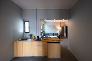 A modern kitchen with a central island, wooden cabinets, and a built-in sink.