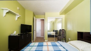 A bedroom with a bed, a TV on a dresser, a chair, and a mirror. - 1 Clean & Cozy Private Bedroom with 1 Private Full Bath (Edmonton)