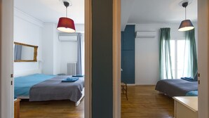 A bedroom with two beds, a mirror, and a dresser. - Amazing Loft In Athens City Center (Athens)