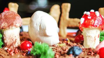A dessert plate with ice cream and decorative mushrooms.