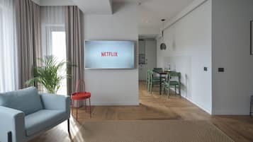 Deluxe Apartment, 2 Bedrooms | Living room | 140-cm Smart TV with cable channels, TV, Netflix