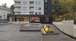 A modern building with a flat roof, rectangular windows, and a central entrance.