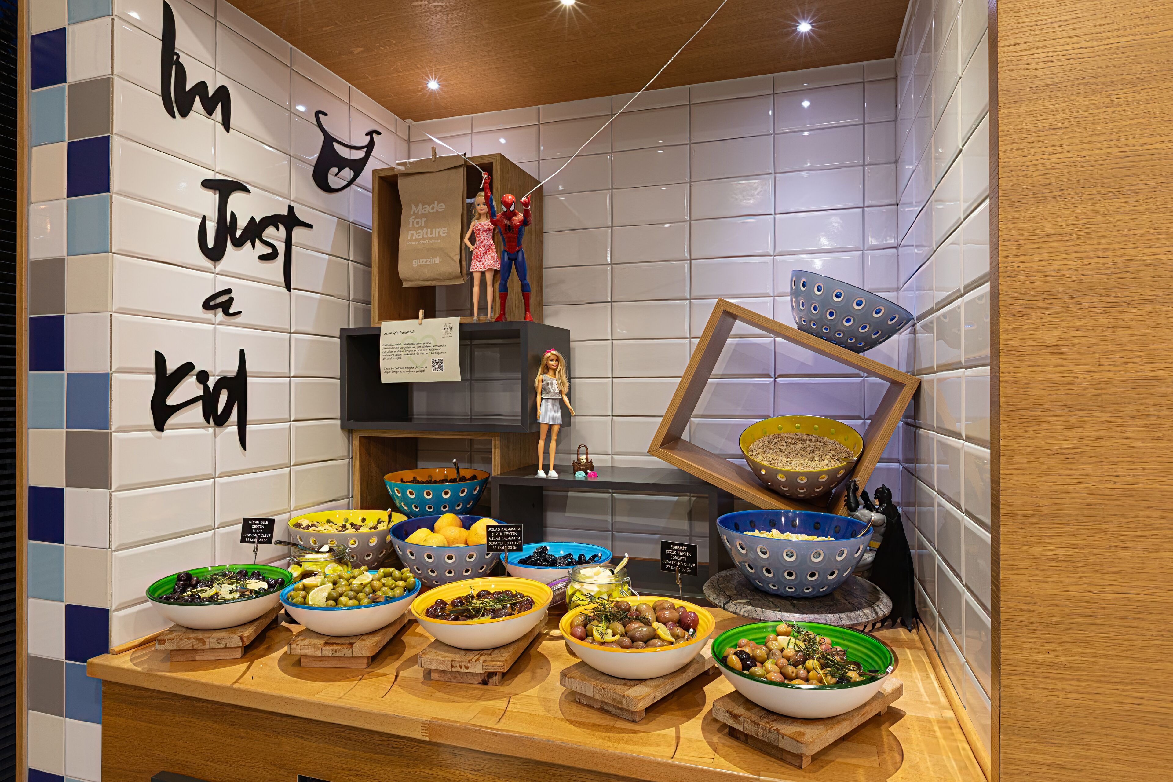A buffet with various dishes and a decorative wall with a message.