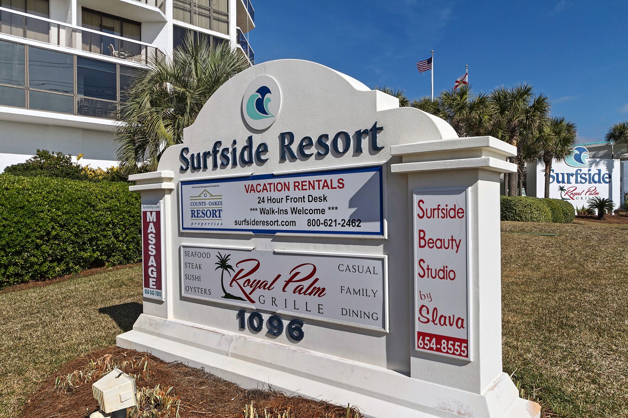 A sign for Surfside Resort with a 24-hour front desk, walk-ins welcome, and contact information.