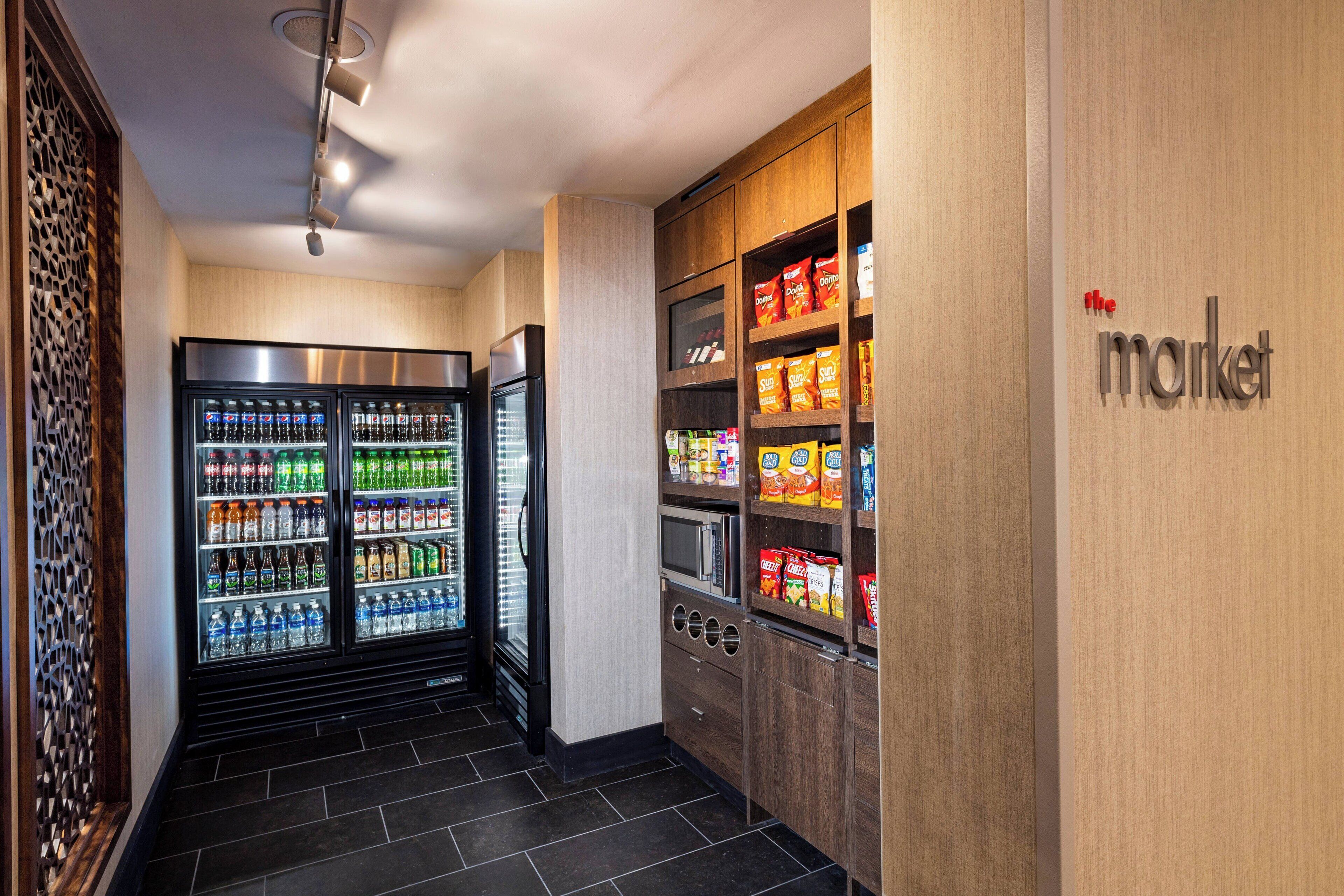 A corridor with vending machines and a wooden wall with a 'market' sign.
