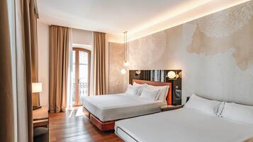 A hotel room with two beds, wooden flooring, a large window with curtains, and a wall with a textured design.