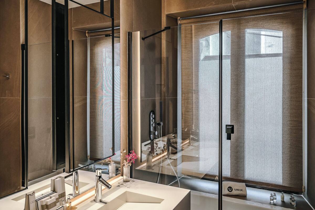 rainfall showerhead, hair dryer, bathrobes, slippers