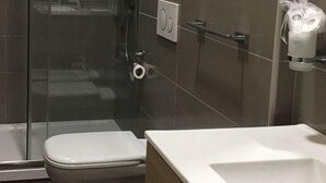 A bathroom with a glass shower enclosure, a white toilet, and a white sink. - B&B Duomo Pizzo ApartHotel (Pizzo)