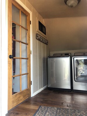 Convenient laundry facilities are available in this room, featuring two washing machines and a dryer.