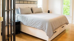 A bedroom with a bed, a ceiling fan, a window, and a door. - Fall color tours!-Awesome Location! Luxury Farmhouse near Wineries & Orchards!! (Fennville)
