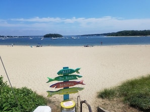 A beach with a signpost indicating 'KEEP The Beach BEAUTIFUL' and 'Please take your trash with you'. - The SandDollar Suite - Private Deck with Gorgeous Views of Onset Beach (Onset)