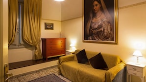 A room with a bed, a nightstand, a dresser, a painting, and a window with curtains. - Tourist House Duomo (Florence)