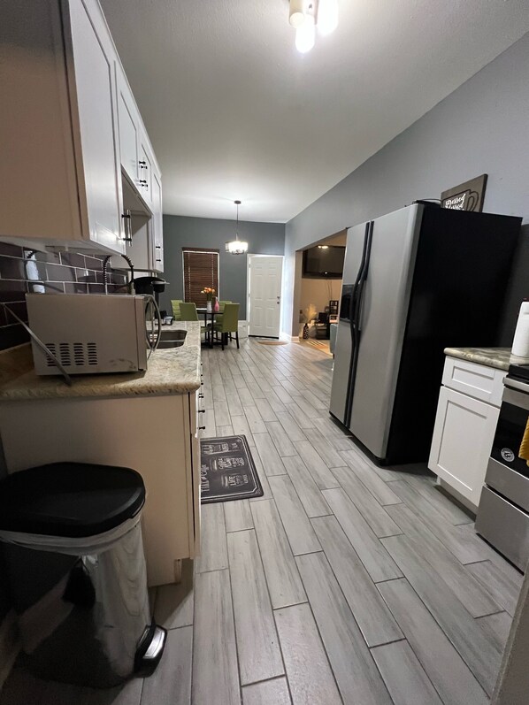 Enjoy cooking and dining in this well-lit kitchen with a central island, ample counter space, and dining area.