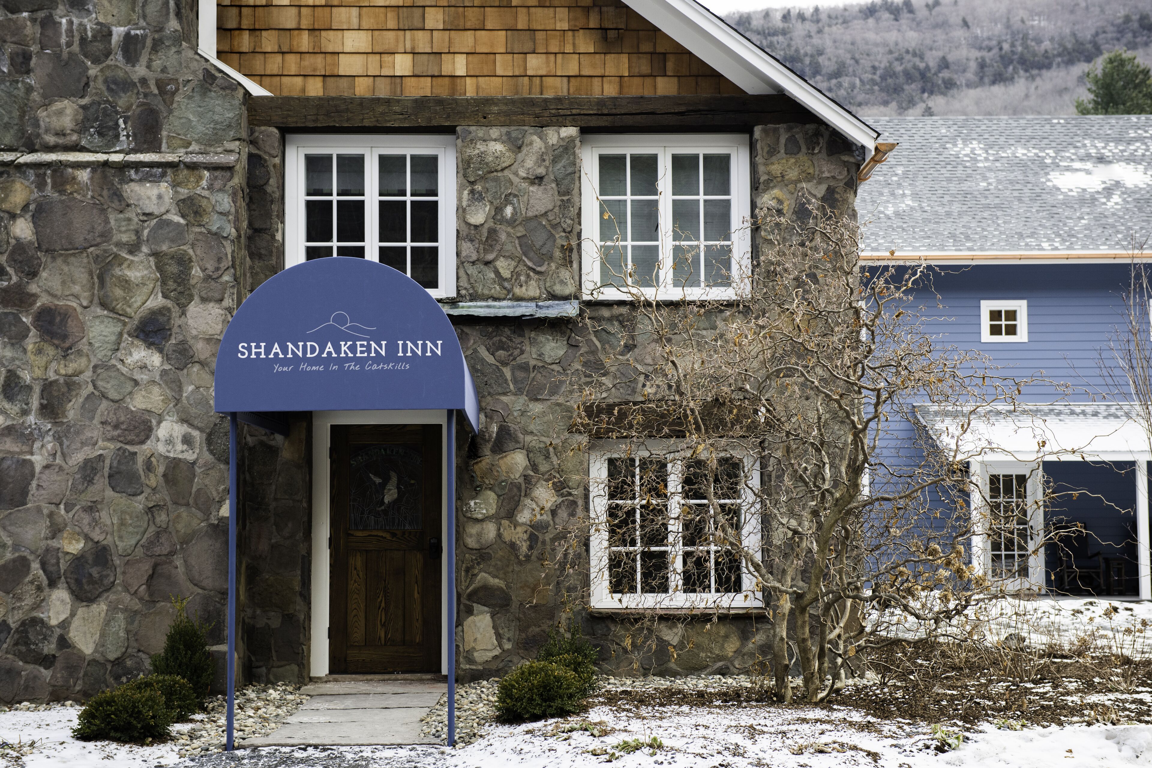 A stone building with a sign for Shandaken Inn.