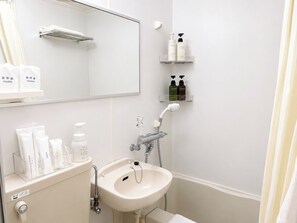 Un baño con lavabo, espejo, toallero y estantes con artículos de aseo.