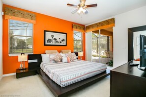 A bedroom with a bed, nightstands, a ceiling fan, and a window with blinds. - Gorgeous Mediterranean Style Pool/spa Home, Only Minutes From Disneyworld #4wr183 (Davenport)