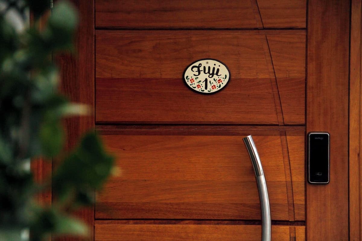 A wooden panel wall with a plaque reading "Fuji 1" and a modern, sleek faucet.
