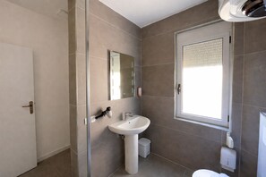 Shower, hair dryer, slippers, towels