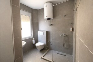 Shower, hair dryer, slippers, towels