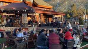 An outdoor seating area with stone walls and wooden furniture, overlooking a mountainous landscape. - HEAVENLY MOUNTAIN RETREAT (Stateline)