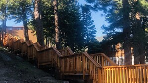 A wooden staircase leading up a hill, surrounded by tall trees. - HEAVENLY MOUNTAIN RETREAT (Stateline)